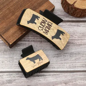 Close-up detail of Western style hair claw clips featuring cow silhouette and Show Mama text