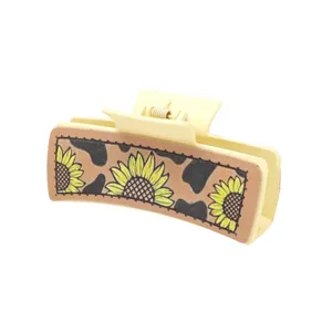 Pince à cheveux style Western avec tournesols et motif vache en cuir pour femme.