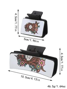 Close-up of Western style claw clips featuring highland cow and floral leather panels.
