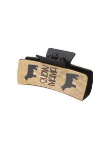Detailed view of western style hair claw clip with cow pattern and SHOW MAMA text