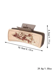 Pince à cheveux en cuir fleuri de style western montrant 10,5cm et le poids exact