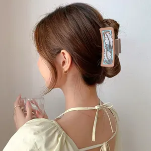 Western style hair claw clip featuring an intricate feather pattern print