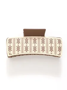 Close-up detail of a vintage brown PU hair claw clip featuring ethnic geometric patterns