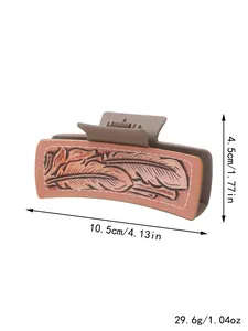 Large western style hair claw clip with embossed feather pattern and product dimensions