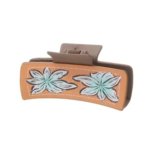 Large Western-style matte brown hair claw clip featuring elegant green floral prints