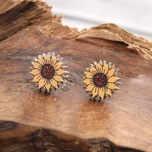 Detailed macro view of rustic wooden sunflower stud earrings on a textured log surface