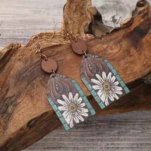 Western style bohemian wooden earrings with white flower pattern displayed on natural wood