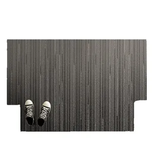 Dark gray striped non-slip entry door mat shown with black and white canvas shoes