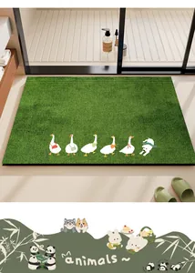 Close-up detail of the green diatom mud bathroom mat with cute cartoon duck illustrations