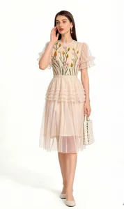 Elegant peach mesh midi dress featuring 3D floral embroidery and tiered ruffle skirt detail