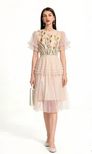 Elegant light pink tulle dress featuring intricate floral embroidery and a tiered skirt design