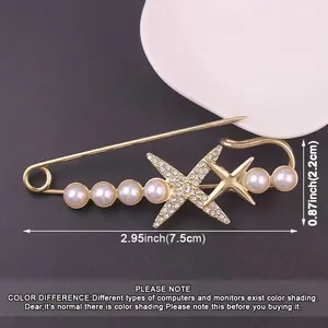 Detailed view of gold pearl rhinestone safety pin brooch with size measurements