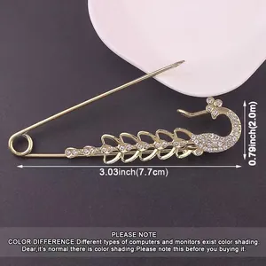 Detail view of a gold-tone peacock brooch with rhinestone accents and dimensions.