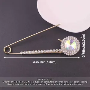 Detailed size view of metal rhinestone safety pin brooch with large circular crystal