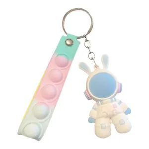 Cute astronaut bunny keychain with pastel gradient pop-it fidget strap for backpacks.