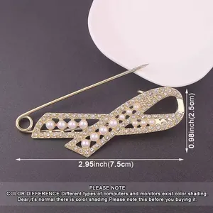 Detailed macro view of gold ribbon brooch with pearls including size measurements info