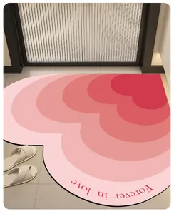 Detailed view of heart-shaped pink gradient absorbent mat with Forever in love text