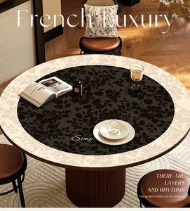 Detail view of a luxury French round floral leather mat on a stylish dining table