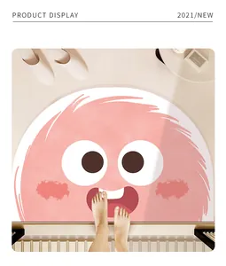 Detail of a cute pink cartoon monster bath mat with feet showing softness and size.