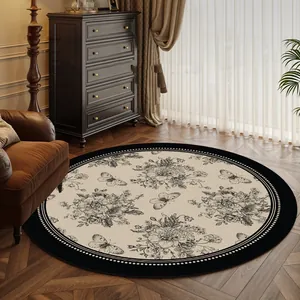 French vintage round area rug with black floral and butterfly pattern for living room