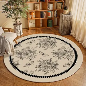 Vintage French style round rug with black floral and butterfly patterns on cream base