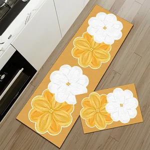 Gedetailleerd zicht op bloemen keukenmatten op houten vloer naast witte kastjes