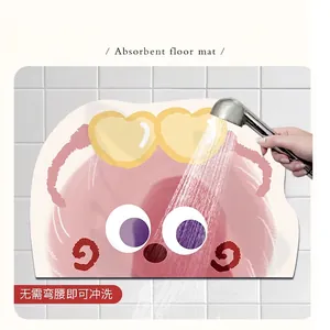 Non-slip cute cartoon absorbent bathroom floor mat being rinsed with a shower head spray