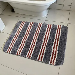 Absorberende badmat met strepen in grijs en oranje-wit, antislip badkamerkleed