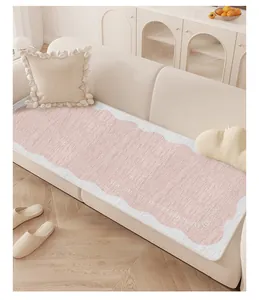 Detailed view of pink and white wavy-edged sofa cushion in cream style home setting