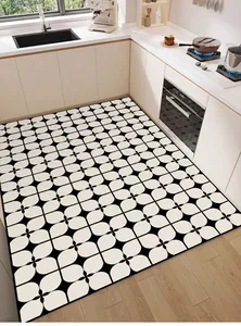 Macro view of black and white geometric patterned kitchen mat on wood floor.