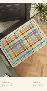 Colorful geometric plaid entryway rug shown in a modern home setting with wooden floor
