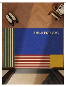 Vintage-style color-block PVC door mat with Smile for Joy text shown on herringbone wood floor
