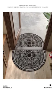 Close-up of semi-circular PVC doormat featuring a detailed black and white mandala pattern