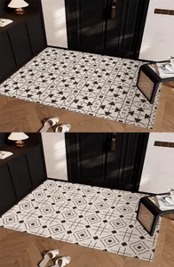 Detail view of two geometric patterned PVC silk loop doormats in a modern hallway