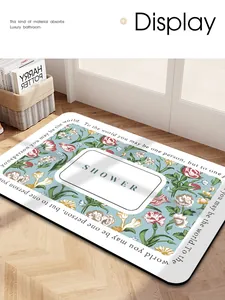 Detailed view of an absorbent floral bathroom mat with 'SHOWER' text in a home setting