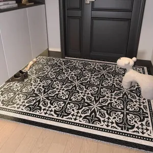 Black and white geometric PVC silk loop entry mat with non-slip backing for indoor use.