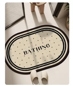 Oval absorbent bathroom mat with BATHING text and geometric patterns in home setting