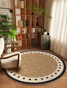 Round Belgian velvet rug with geometric border styled in a modern wooden study room.
