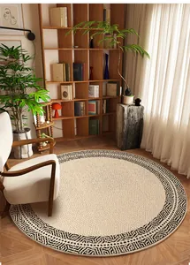 Round Belgian velvet rug with geometric border in a cozy reading nook setting