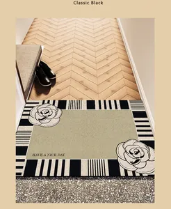 Close-up detail view of cream-style entrance mat with floral pattern and black stripes.