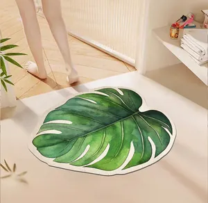Tapis de bain absorbant en terre de diatomée en forme de feuille de monstera.