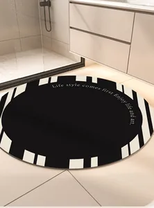 Modern round absorbent bathroom floor mat with a black and white geometric border