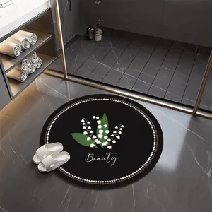 Modern round black absorbent bathroom mat with white lily floral pattern and Beauty text