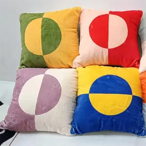 Detail view of colorful geometric throw pillow covers with circular color blocking.
