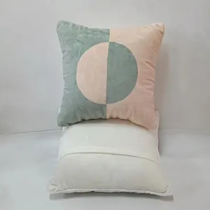 Close-up showing the geometric pattern and plain white back of these sofa pillow covers.