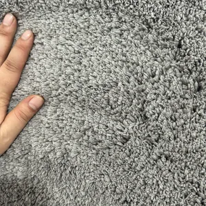 Close-up detail of grey thick long-piled cake velvet rug showing soft fiber texture