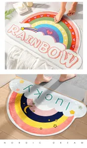 Detail view of semi-circular bath mats featuring 'RAINBOW' and 'lucky' colorful patterns.