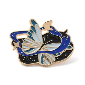 Detailed macro shot of an enamel butterfly and galaxy themed brooch