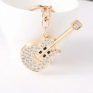 Elegant gold guitar model keychain with sparkling rhinestones for bags or car keys