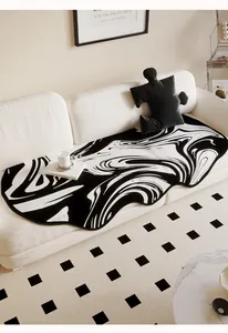 Detail view of irregular Dornier sofa cushion with black and white marble swirl pattern
